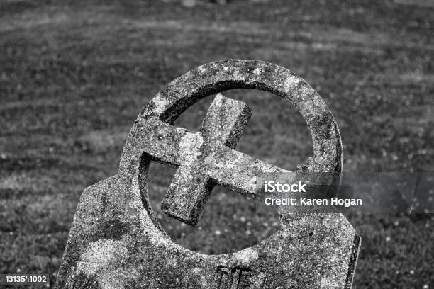 Christian Cross Inside A Circle Adorning A Tombstone Stock Photo - Download Image Now
