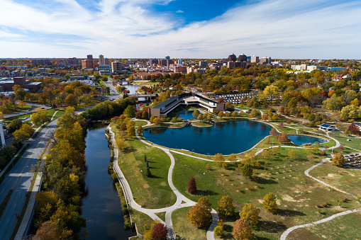 Aerial of Kansas City's Country Club Plaza (background) and Rockhill (right) neighborhoods during Autumn, with Kauffman Legacy Park and Brush Creek in the foreground.