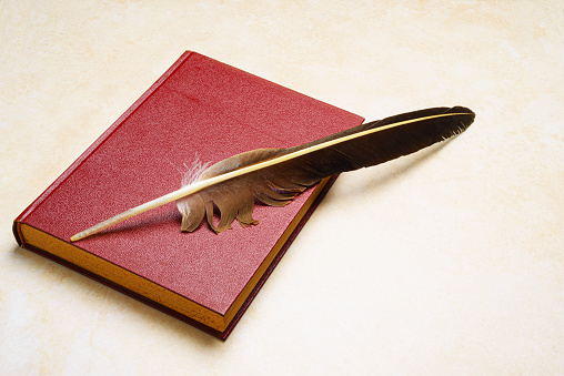 Old book with feather .Conceptual image