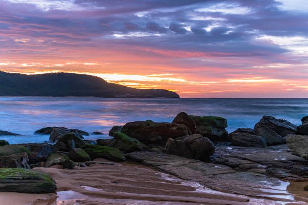 istock Sunrise at the seaside with pastel coloured clouds 1313547516