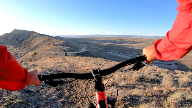 istock Mountain biker follows desert pathway in the morning 1313547556