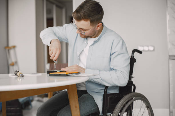 istock Young disabled man repairing motherboard at kitchen 1313548634