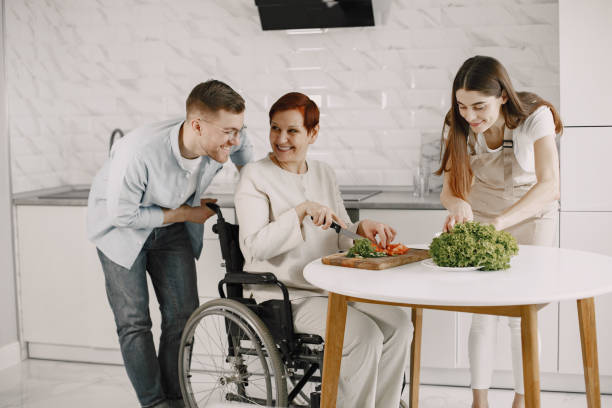 istock Mature disabled woman cutting vegetables in the kitchen 1313548650