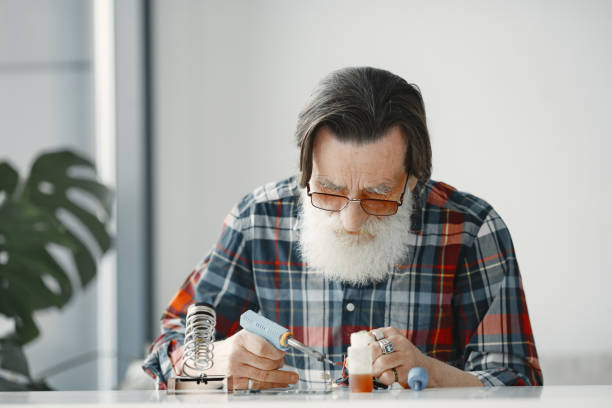 istock Male tech repairs electronic equipment at home 1313549542