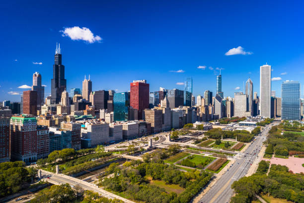 Chicago Downtown Aerial And Grant Park Downtown Chicago Skyline Aerial with a deep blue sky in the background and Grant Park in the foreground. willis tower stock pictures, royalty-free photos & images