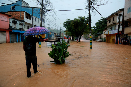 salvador, bahia / brazil - april 27, 2015: people are seen in flooded area due to rain in the Narandiba neighborhood in the city of Salvador.
