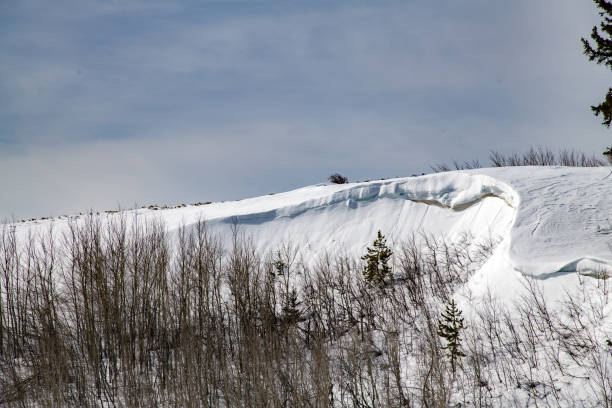 istock Snow overhanging a hill top 1313551581