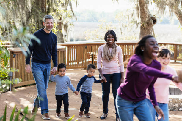 istock Blended family with five children walking in park 1313552914
