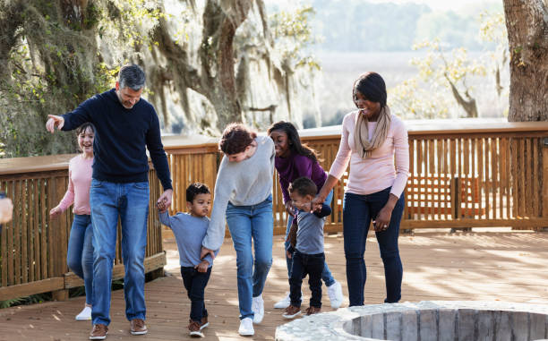 istock Blended family with five children walking in park 1313552933