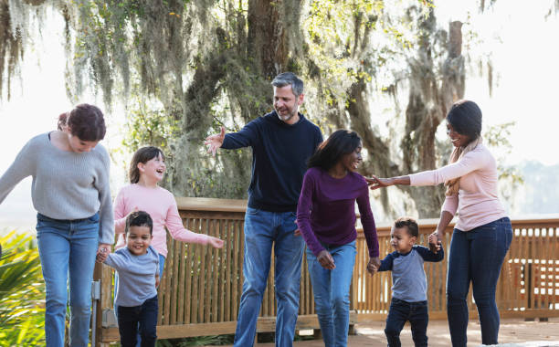 istock Blended family with five children walking in park 1313553034