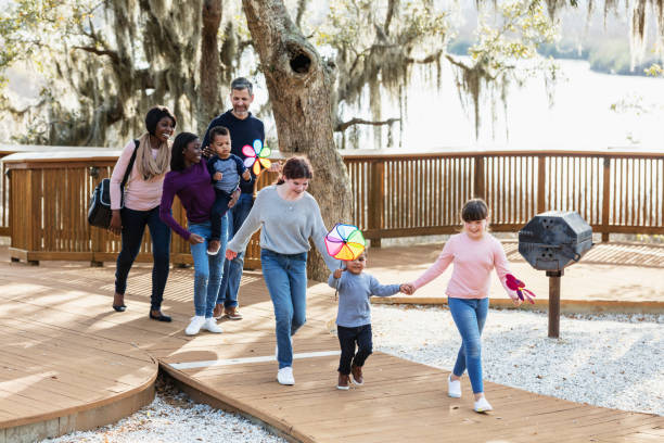 istock Blended family with five children walking in park 1313553057