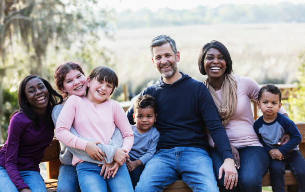 istock Blended family with five children sitting on park bench 1313553207