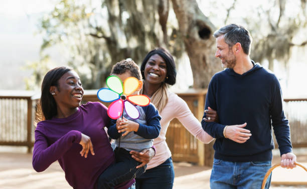 Blended interracial family walking in park