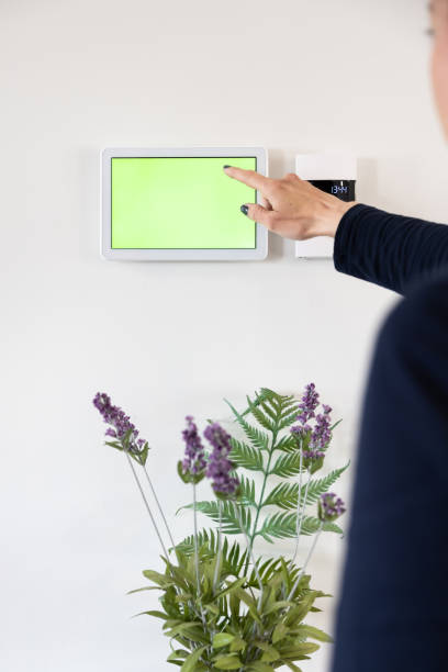 istock Woman Using Home Automation on Digital Tablet (Green Screen / Chroma Key) 1313554055