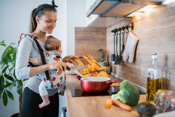 istock A mother preparing food with her baby. 1313556018