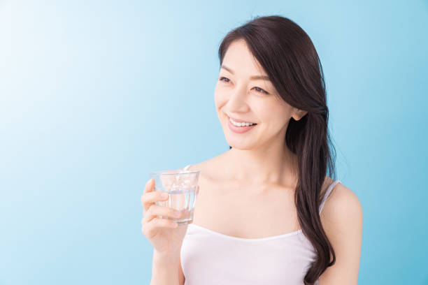istock attractive asian woman who drinks water 1313561764
