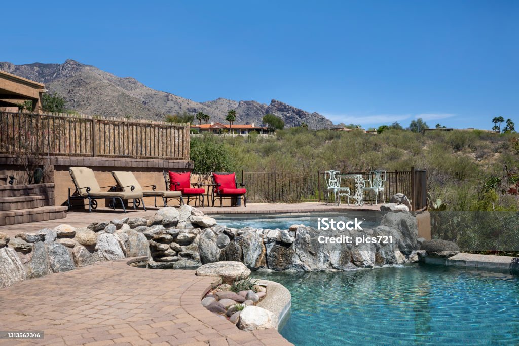 Swimming pool with terraced patio Swimming pool with hot tub and terraced patio at a luxury home in a desert environment. Luxury Stock Photo