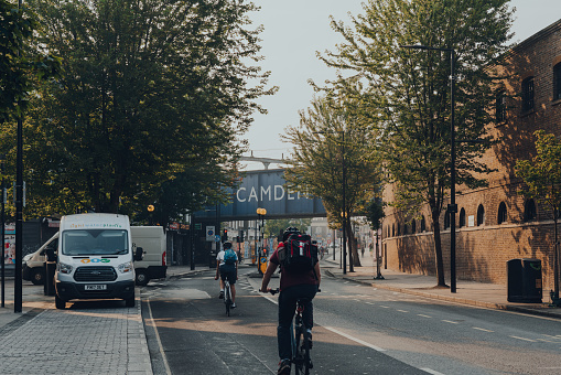 London, UK - August 12, 2020: Cyclists on the road in Camden, London, motion blur. Cycling became a popular option for commuting in the capital.
