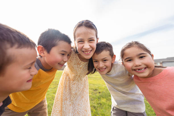 istock Smiling group of elementary age kids outdoors 1313564663