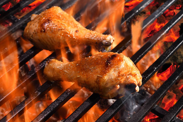 istock Grilled chicken legs on the flaming grill 1313568253
