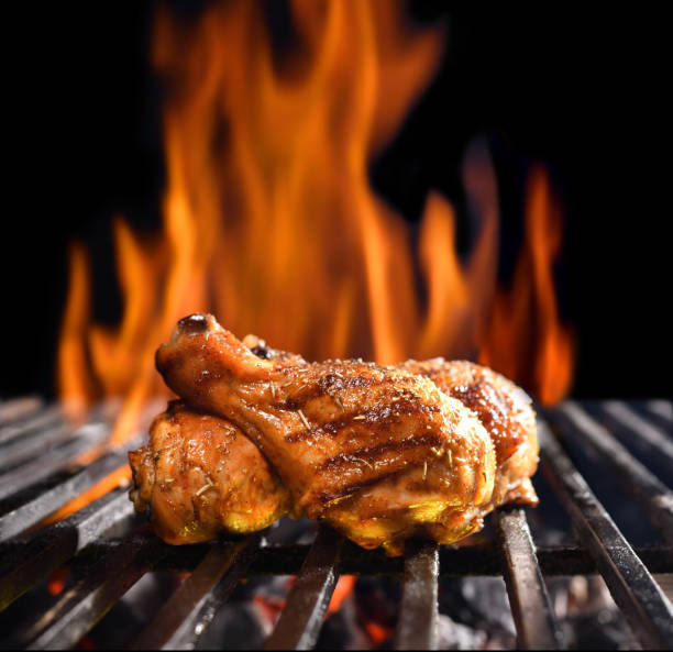 istock Grilled chicken legs on the flaming grill 1313568262