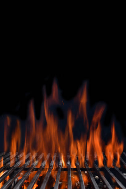 istock Flaming charcoal grill for barbeque on empty black background 1313568263