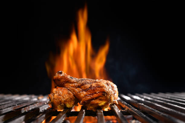 istock Grilled chicken legs on the flaming grill 1313568276