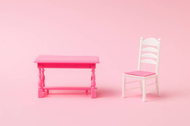 istock A light chair and a red table on a light pink background. 1313570030