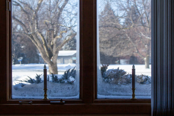 istock Abstract view of an ice lined window with holiday candle sticks 1313570908