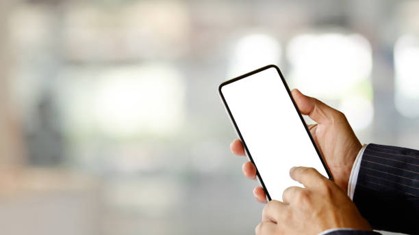 istock Close up view of businessman hands using smartphone in blurred background 1313574072