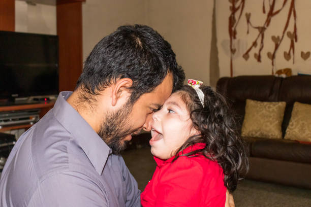 istock Young hispanic father hugging daughter and looking into her eyes, father's day concept 1313574130