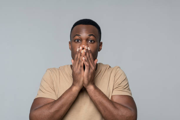 istock Surprised man covering his mouth with hands 1313574949