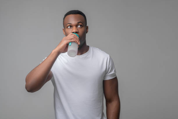 istock Man drinking water from sports bottle 1313575168
