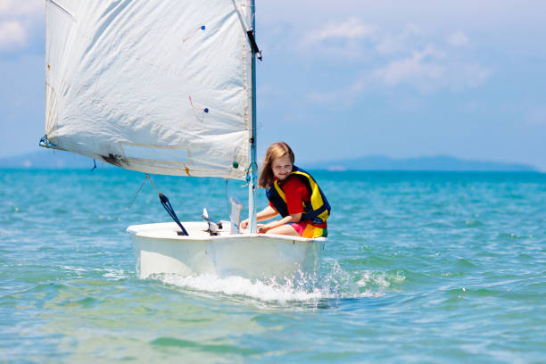 criança velejando. garoto aprendendo a velejar em iate marítimo. - sailboat sports race yachting yacht - fotografias e filmes do acervo