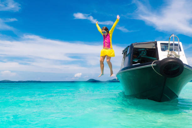 niño saltando al agua del mar. vacaciones en yates. - clear sky water sports and fitness yacht fotografías e imágenes de stock