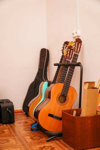 istock Several acoustic guitars on a stand in room 1313580197