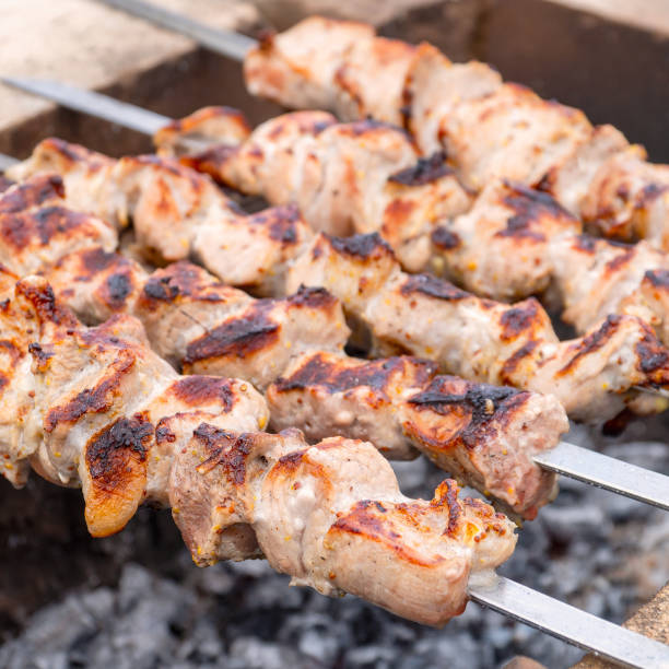 istock Roasted meat cooked at barbecue and skewers during picnic 1313580228