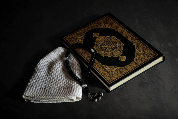 istock Holy quran with prayer beads beads and muslim cap 1313580579