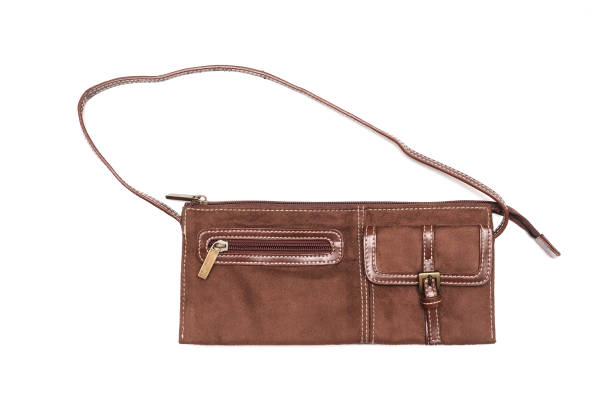 Closeup shot of a woman's hands holding leather brown  bag
