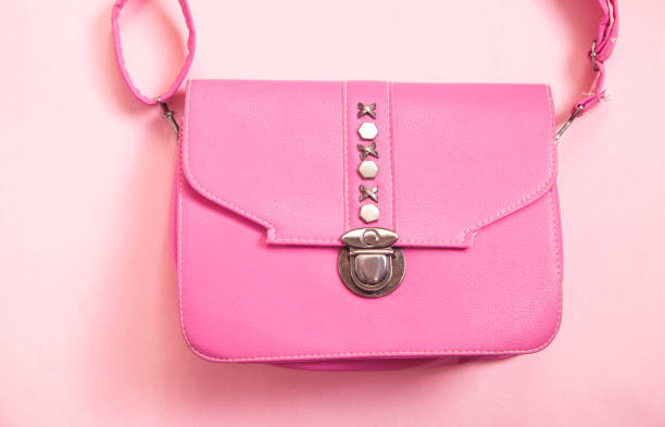 istock Pink leather handbag on pink background. 1313581160