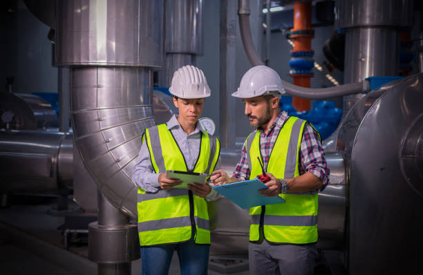 istock Industry engineer under checking the industry cooling tower air conditioner is water cooling tower air chiller HVAC of large industrial building to control air system. 1313581288
