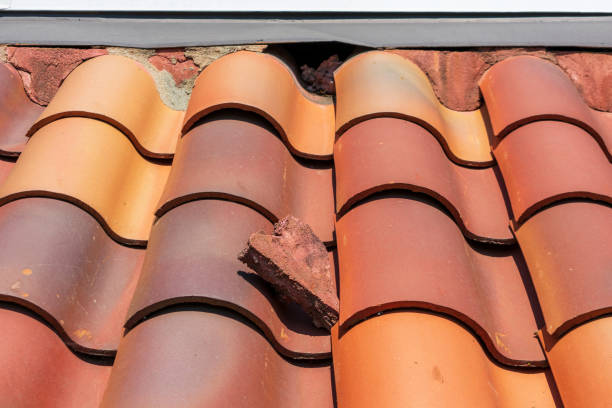 istock Clay roof tile deterioration. Loose ridge capping mortar 1313581305