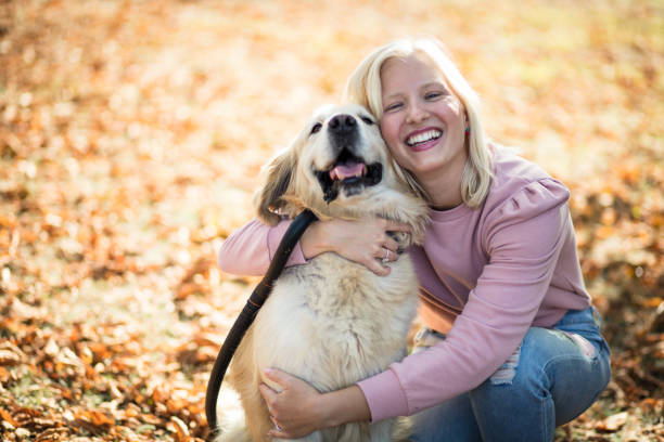 istock Woman relaxing in a park with her dog. 1313583313