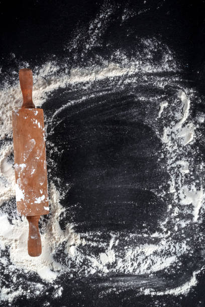 istock Baking background with white flour and a wooden rolling pin 1313584303
