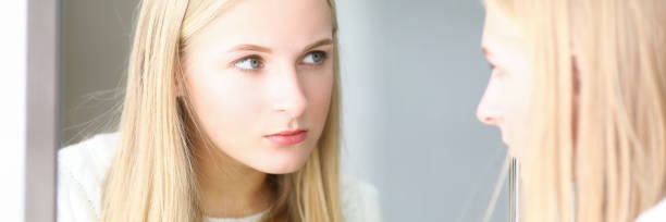 istock Blonde woman looking at mirror, beauty studio 1313584329