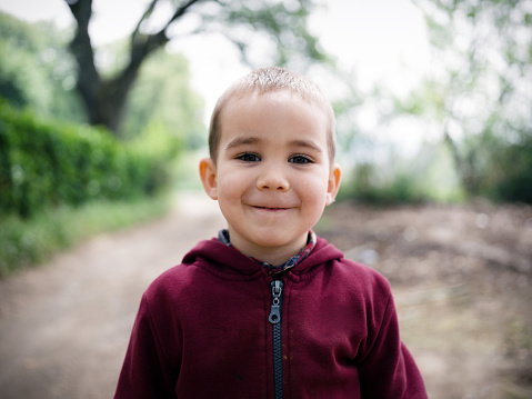 Portrait Of Child Boy Outdoors In Spring Season