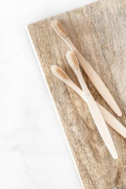 istock Composition with biodegradable bamboo toothbrushes on wooden background. 1313587190