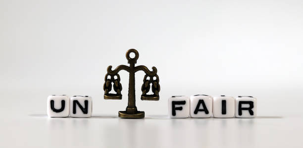 istock Miniature scale between cube with word 'UN' and cube with word 'FAIR'. The concept of a fair society. 1313587398