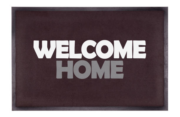 Modern black doormat isolated on white - Welcome home