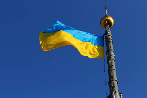 istock Ukraine flag on blue sky background 1313592368